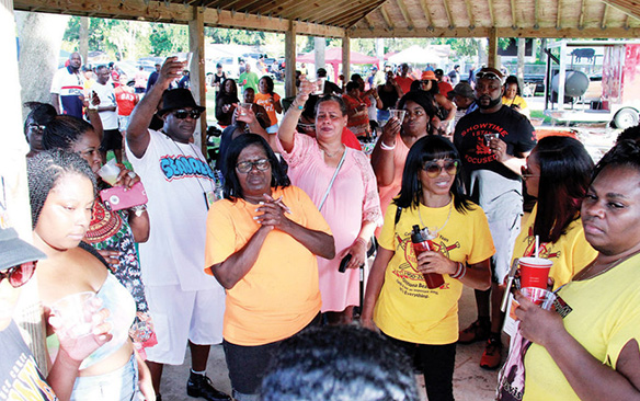 Reunion attendees say a prayer for classmates who have passed away. (Photo by: Duane C. Fernandez Sr. | hardnottsphotography.com)