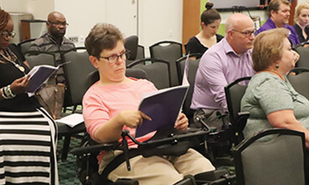 Rhonda Clark, a frequent user of WeGo’s on-demand service, reading the meeting agenda and studying the proposed changes MTA board approved last week.
