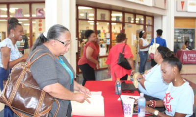 Semi-retired kindergarten teacher Sandra Jenkins checks in with district personnel at a Shelby County Schools job fair. July 11, 2019. (Photo by: Kathryn Palmer | Chalkbeat)