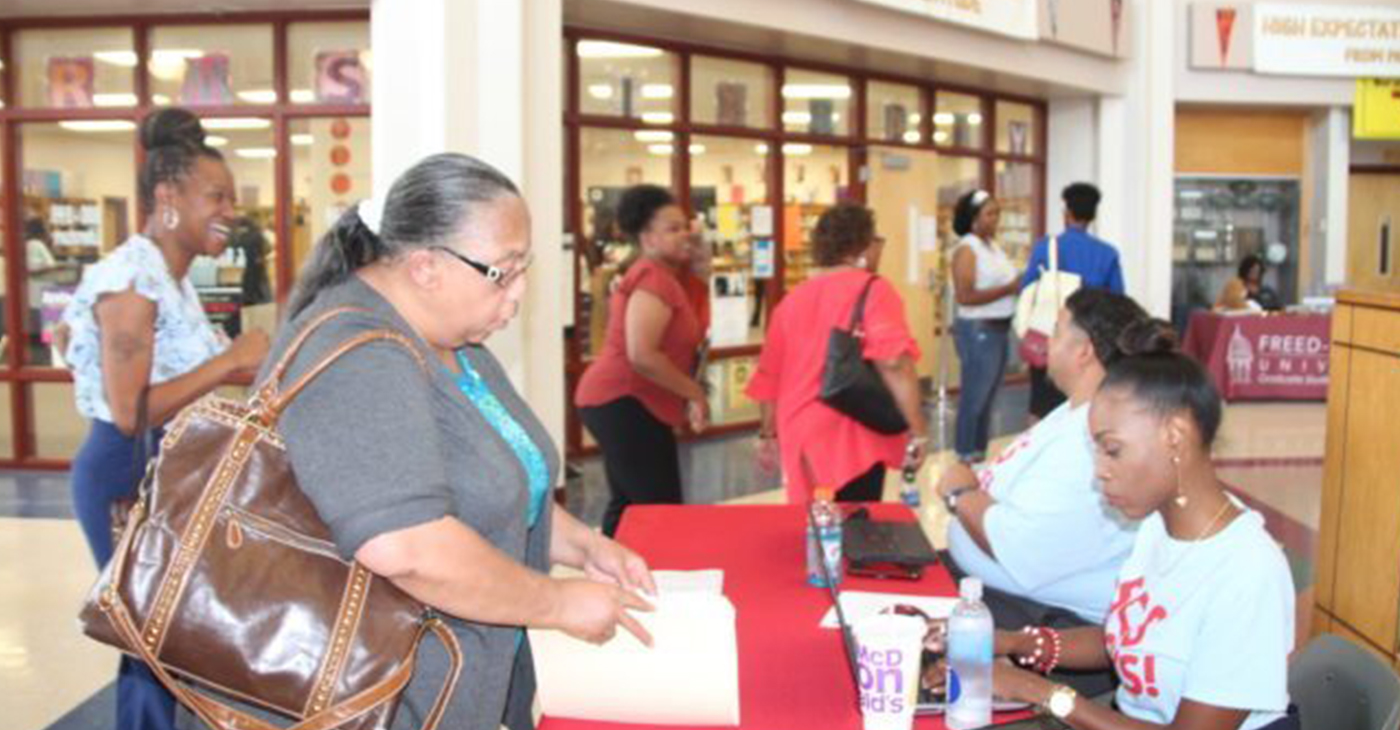 Semi-retired kindergarten teacher Sandra Jenkins checks in with district personnel at a Shelby County Schools job fair. July 11, 2019. (Photo by: Kathryn Palmer | Chalkbeat)