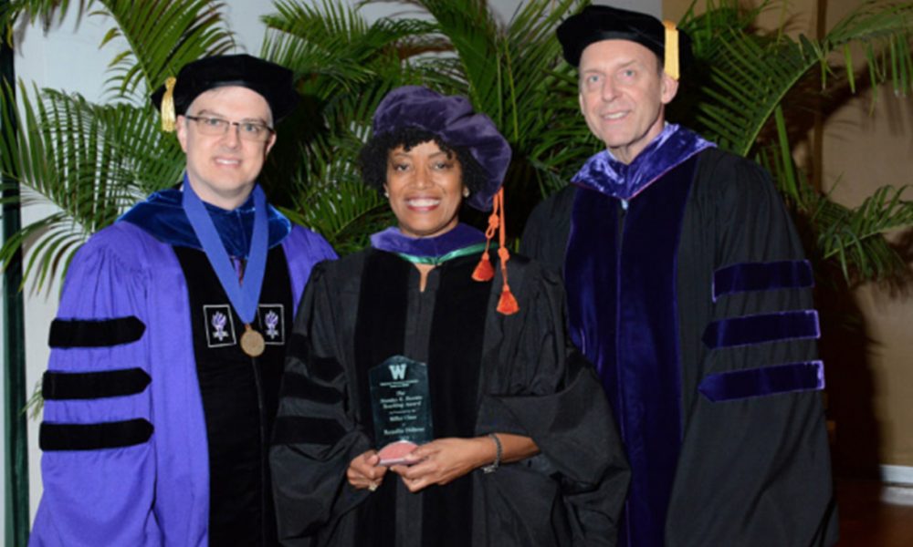 Beattie Award for Excellence in Teaching during the law school's commencement ceremony on Aug. 7. Pictured with Dubose (center) are Associate Dean Daniel Matthews (left) and President and Dean James McGrath.