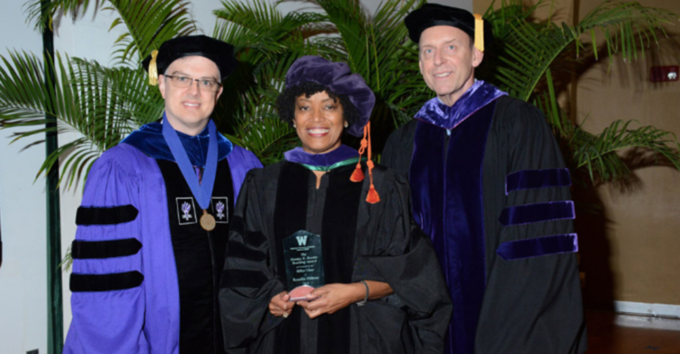 Beattie Award for Excellence in Teaching during the law school's commencement ceremony on Aug. 7. Pictured with Dubose (center) are Associate Dean Daniel Matthews (left) and President and Dean James McGrath.