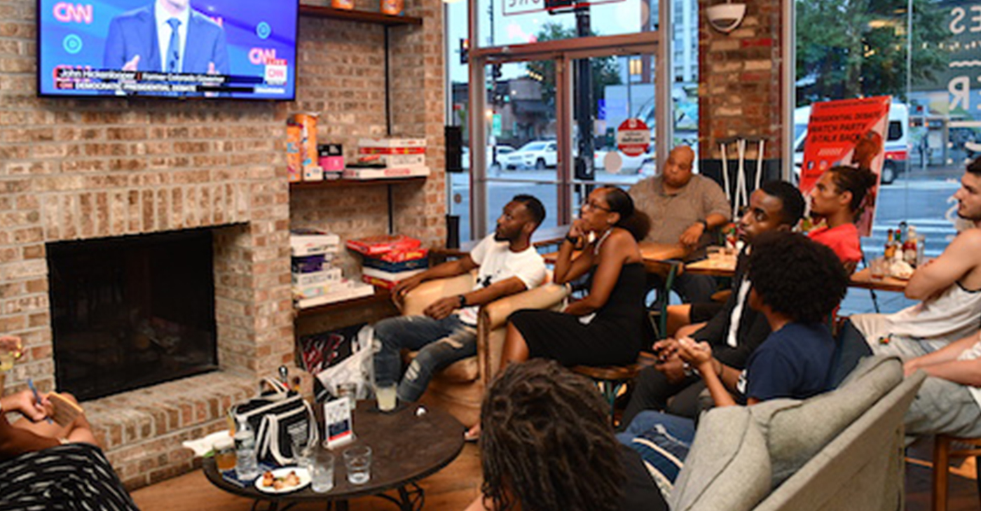 Young people gathered at Halfsmoke in Northwest on Tuesday, July 30 to watch the first night of the second round of Democratic debates with members of #BlackYouthVote. (Anthony Tilghman/The Washington Informer)