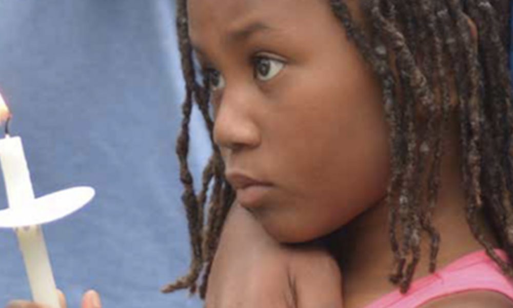 A little girl holds a candle during a vigil in southeast D.C. for Karon Brown, 11, who was killed by an adult after a dispute with other children. (Courtesy of Ward 8C07 Commissioner Salim Adofo)