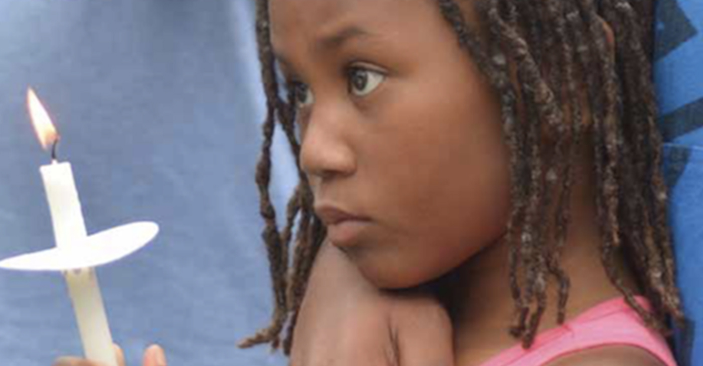 A little girl holds a candle during a vigil in southeast D.C. for Karon Brown, 11, who was killed by an adult after a dispute with other children. (Courtesy of Ward 8C07 Commissioner Salim Adofo)