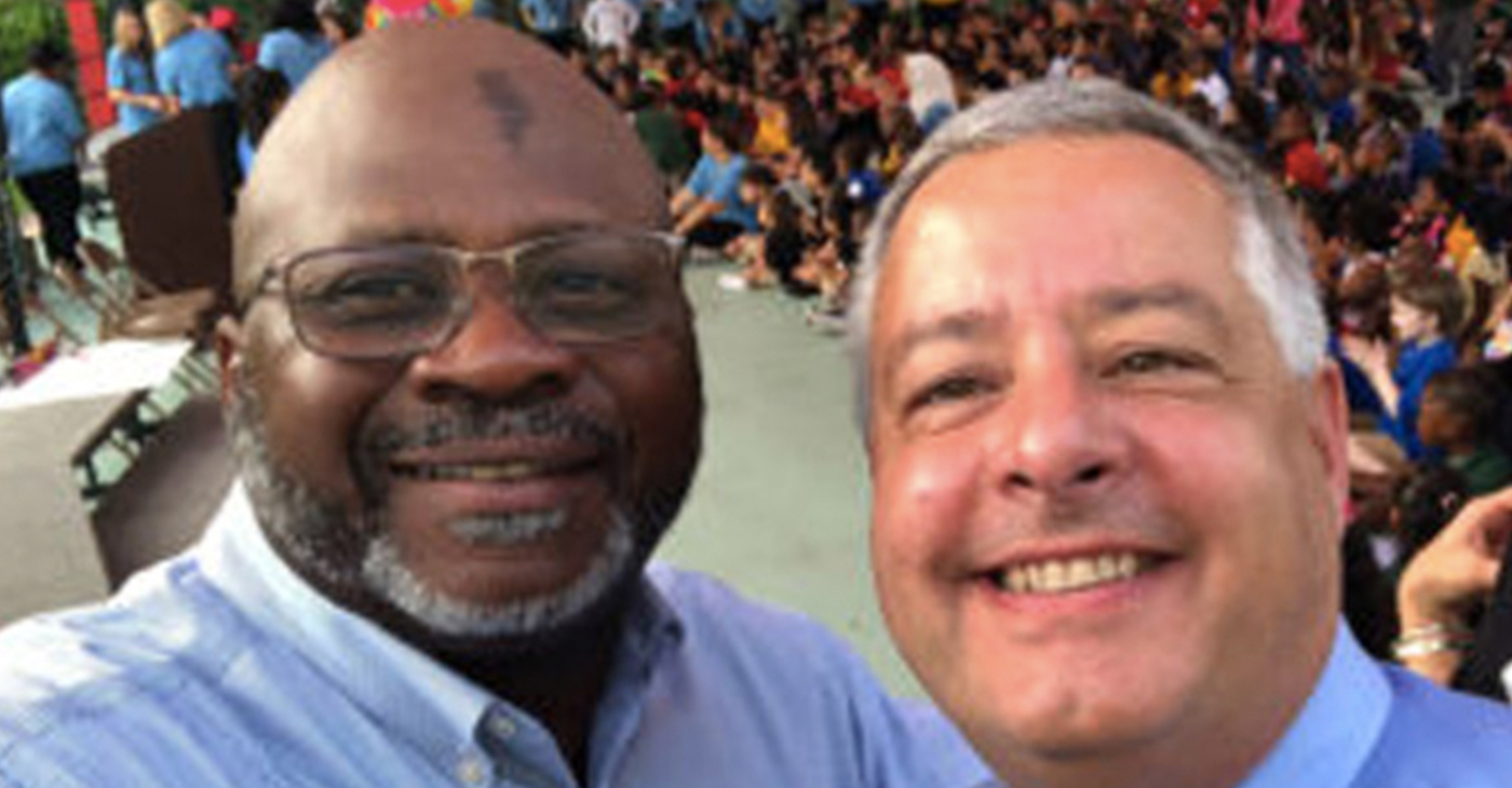 Vistra Communications CEO Brian Butler, left, is shown with former Mort Elementary School Principal Woodland Johnson.