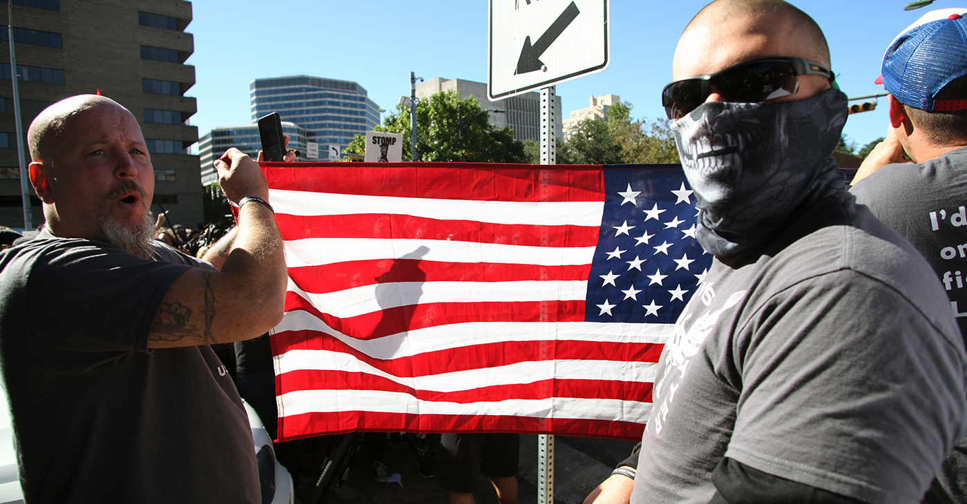 Austin, Texas, USA - November 19, 2016: 'White Lives Matter' demonstrators display an American flag at a protest just south of the Capitol grounds. The 'White Lives Matter' demonstrators, numbering about 20 people at the most, came from Houston with the message that the hate crime law is unfair to white people. (Photo: iStockphoto / NNPA)