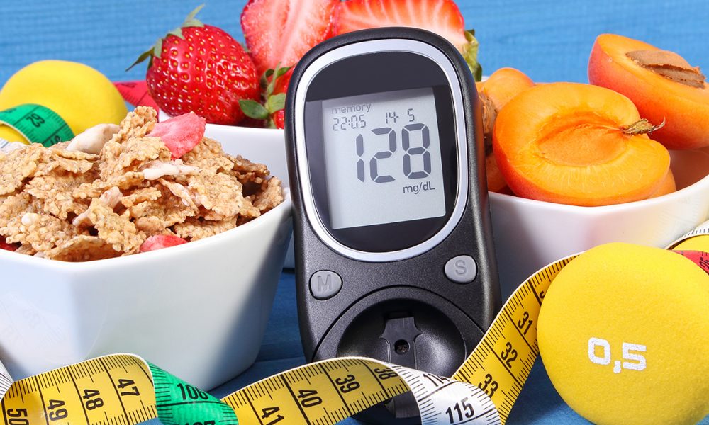 Glucose meter with result sugar level, healthy food, dumbbells and centimeter, diabetes (Photo by: Ratmaner)
