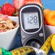 Glucose meter with result sugar level, healthy food, dumbbells and centimeter, diabetes (Photo by: Ratmaner)