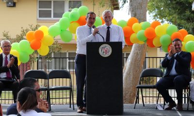 Mayor Eric Garcetti and HACLA President and CEO Doug Guthrie share a moment on stage (Courtesy Housing Authority of the City of Los Angeles)