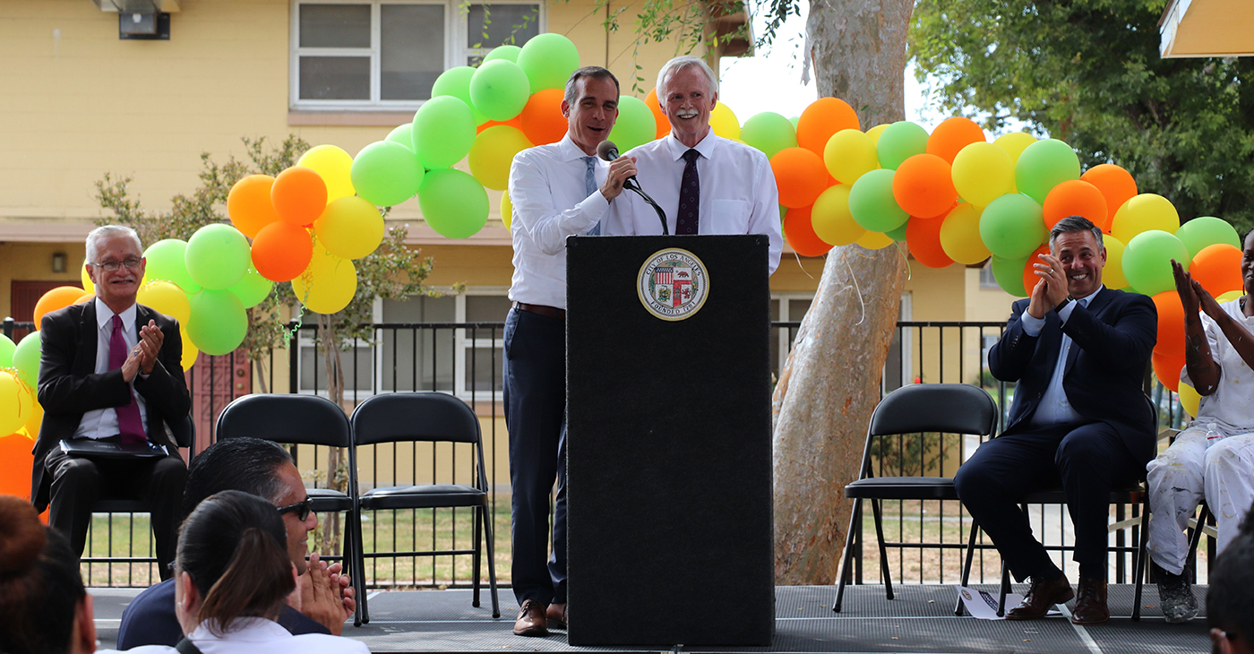 Mayor Eric Garcetti and HACLA President and CEO Doug Guthrie share a moment on stage (Courtesy Housing Authority of the City of Los Angeles)