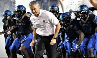 Mike Norvell and the Memphis Tigers rush out to meet the Navy Midshipmen at the Liberty Bowl Stadium on Thursday night. (Photo: Terry Davis)
