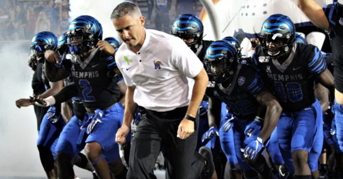 Mike Norvell and the Memphis Tigers rush out to meet the Navy Midshipmen at the Liberty Bowl Stadium on Thursday night. (Photo: Terry Davis)