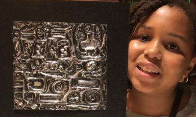Zoe holding her first repousse piece created in MICA’s after school arts program, that she sold to Fogo de Chao manager. (Photo by Latease Lashley)