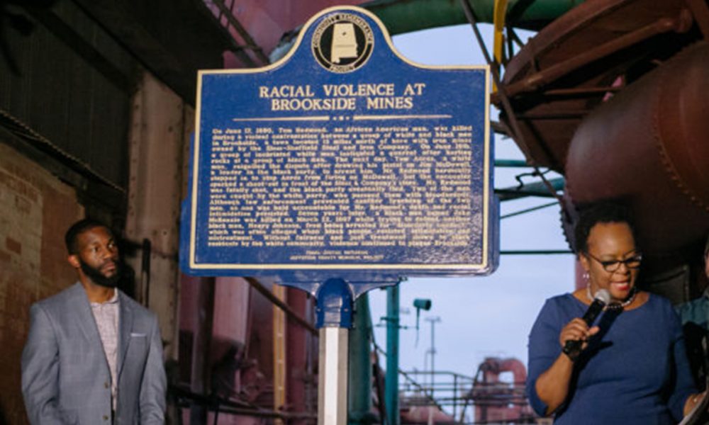Denise Gilmore, Director of Cultural Preservation, City of Birmingham, (with mic), and Mayor Randall Woodfin (left) during unveiling of the historical lynching marker. (Photo by: City of Birmingham)