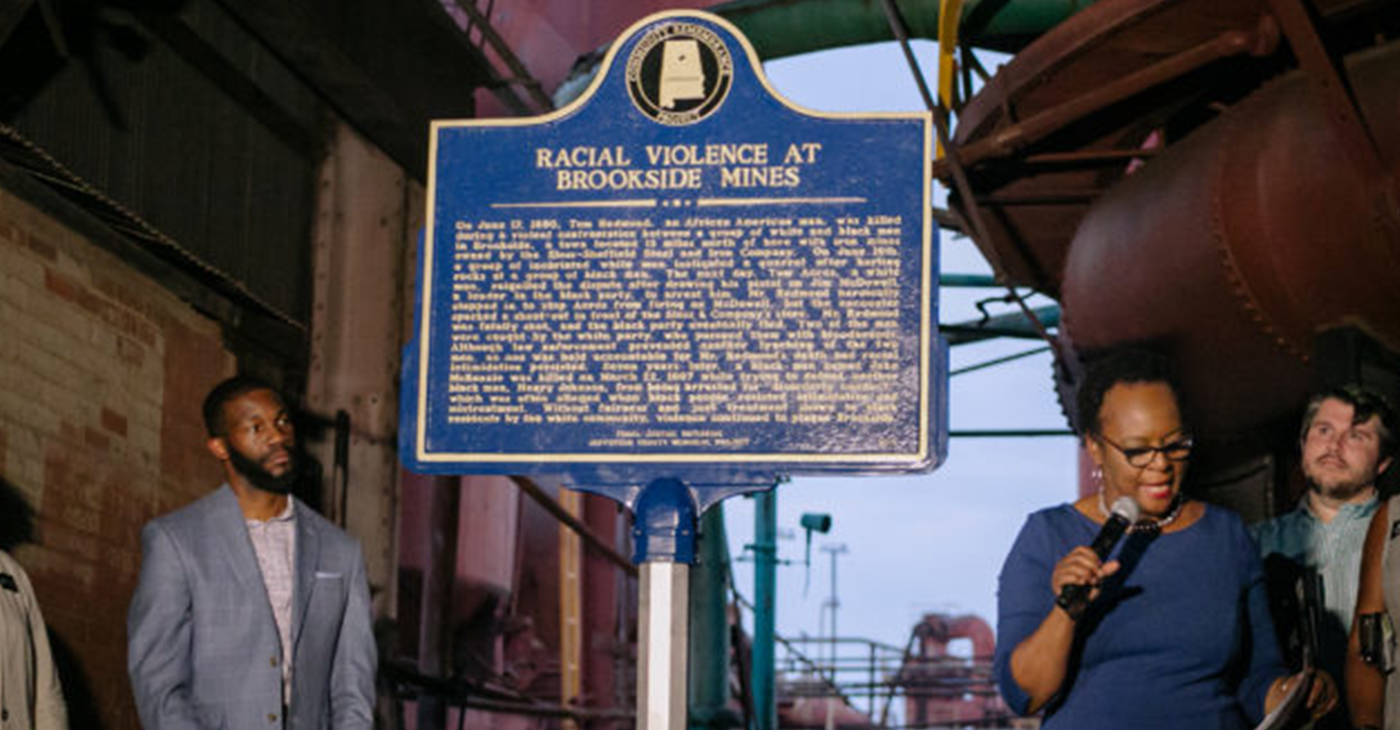 Denise Gilmore, Director of Cultural Preservation, City of Birmingham, (with mic), and Mayor Randall Woodfin (left) during unveiling of the historical lynching marker. (Photo by: City of Birmingham)