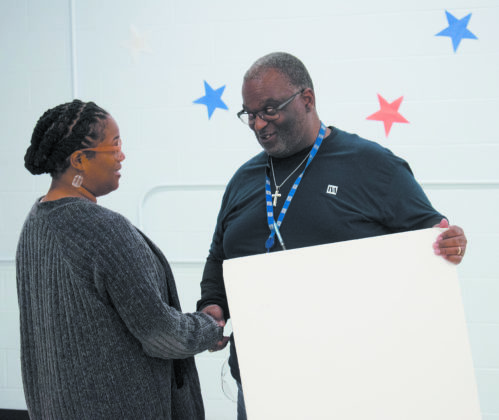 Tennessee Valley Authority retirees presented Riverview K-8 School Principal Rasheedah Cooperwood with a $1,000 check for the school’s robotics program. (Photo by: Karanja A. Ajanaku)