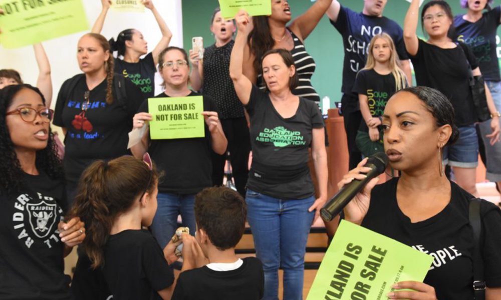 Protest against school closings at recent Oakland school board meeting. (Photo by: Ken Epstein)