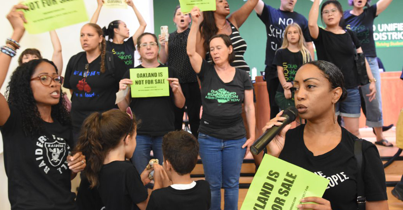 Protest against school closings at recent Oakland school board meeting. (Photo by: Ken Epstein)