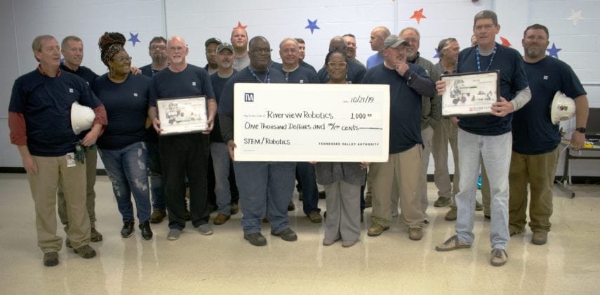 Tennessee Valley Authority retirees presented Riverview K-8 School Principal Rasheedah Cooperwood with a $1,000 check for the school’s robotics program. (Photo by: Karanja A. Ajanaku)