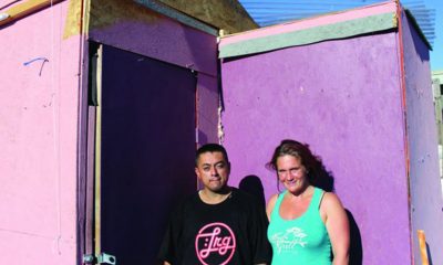 José Vargas (left), who’s lived in Oakland since he was three, and Jillian Wright, who’s lived in the Bay Area all her life, take a short break from disassembling their self-made home. After the City of Oakland forced them to take down their home, they offered them no alternative housing. (Photo by: Zack Haber).