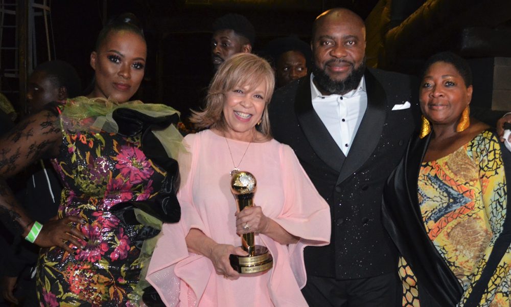 Ms. Helen Giddings (Standing) Left to Right: Ifeoma Obiagwu; Helen Giddings (AFRIMMA Transformational Leadership Award Recipient); Anderson Obiagwu (CEO, Big A Entertainment and Founder of AFRIMMA Awards); and Regina Onyeibe (City of Dallas, Africa Liaison). Photo Credits: Earnestine Cole