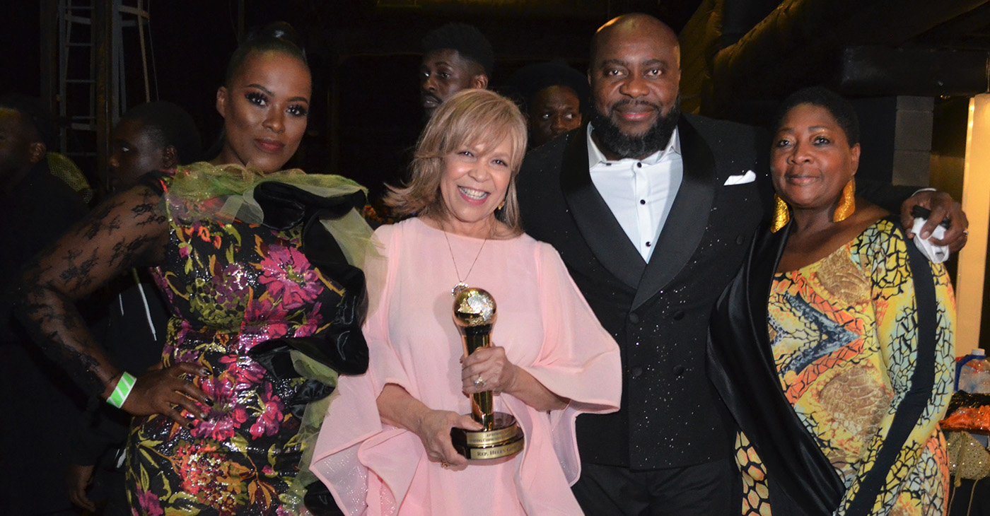 Ms. Helen Giddings (Standing) Left to Right: Ifeoma Obiagwu; Helen Giddings (AFRIMMA Transformational Leadership Award Recipient); Anderson Obiagwu (CEO, Big A Entertainment and Founder of AFRIMMA Awards); and Regina Onyeibe (City of Dallas, Africa Liaison). Photo Credits: Earnestine Cole