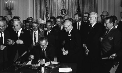 President Lyndon B. Johnson signs the 1964 Civil Rights Act as Martin Luther King, Jr., and others, look on, July 2, 1964. (Photo: Cecil Stoughton, White House Press Office [WHPO] / Wikimedia Commons)