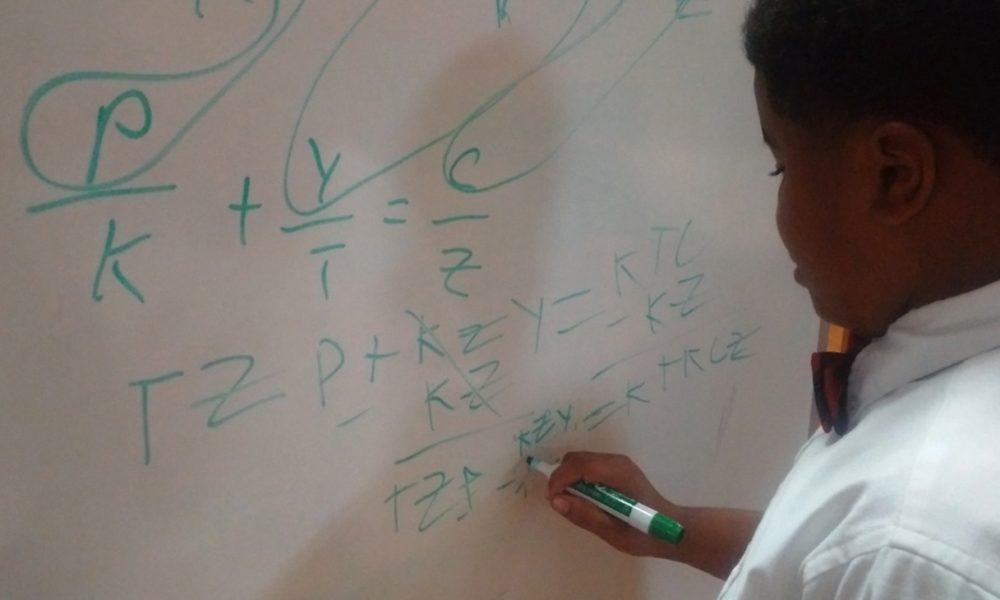 T.M Landry 5th grader D'Myrie Clay completes algebra problem for high school peers.