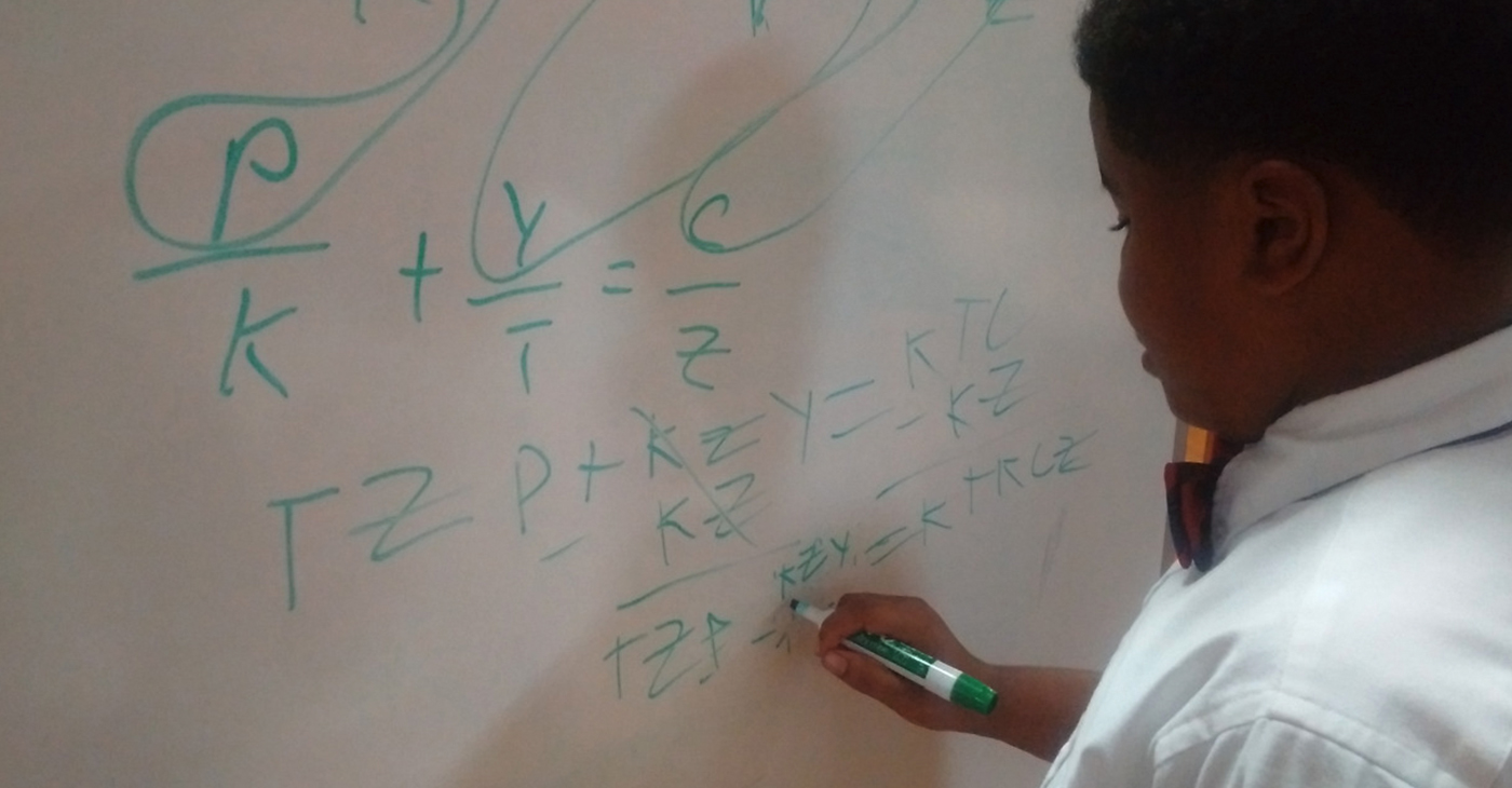T.M Landry 5th grader D'Myrie Clay completes algebra problem for high school peers.
