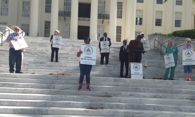 Leaders in the SaveOurSelves Movement for Justice and Democracy, are here on the steps of the Alabama Capitol standing up six feet apart so Alabamians will not have to be lying six feet under.