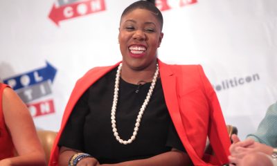 A seasoned political strategist, Sanders gained national prominence in 2016 as the National Press Secretary for U.S. Sen. Bernie Sanders’ then-presidential campaign. (Photo: Symone Sanders speaking at the 2016 Politicon at the Pasadena Convention Center in Pasadena, California. | Gage Skidmore | Wikimedia Commons).
