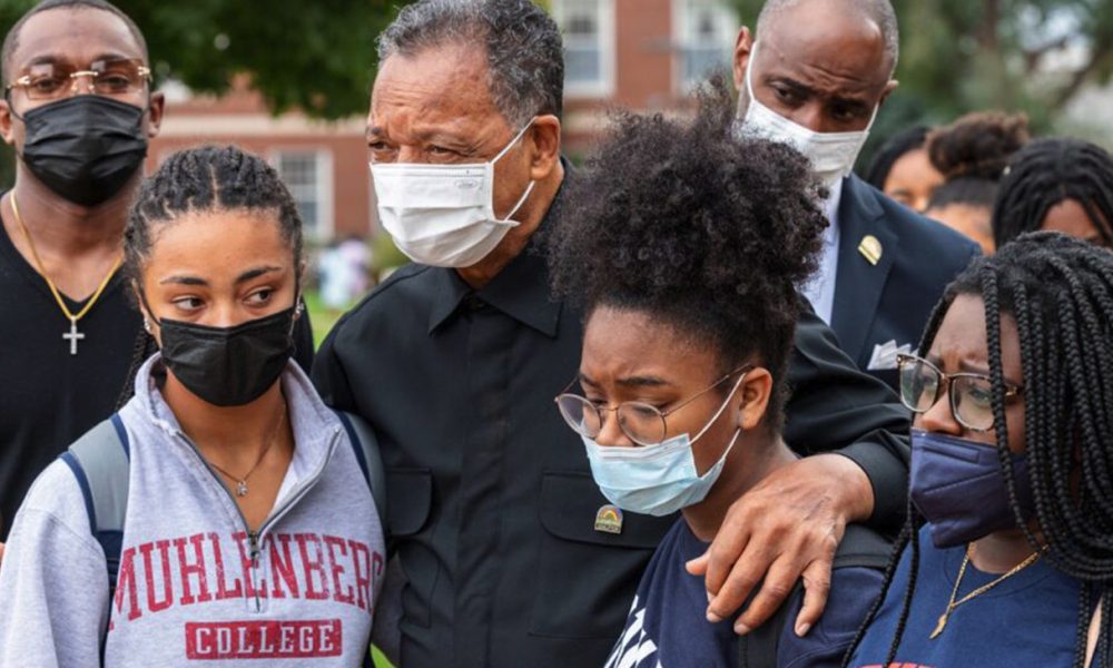 Channing Hill and Erica England headed inside of the Armour J. Blackburn Center with Rev. Jesse Jackson on Sunday, Oct. 31, after Sunday’s Chapel service. Photo courtesy of Jon Musselwhite. / The Hilltop