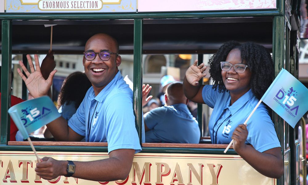 Disney Dreamers Academy students come from all walks of life and experiences. (March Disney Dreamers Academy alumni Matthew Young (L) and April Breedlove (R) wave as part of a celebratory parade to kick off the 15th annual Disney Dreamers Academy Thursday, March 3, 2022 at Walt Disney World Resort in Lake Buena Vista, Fla. The Disney Dreamers Academy, taking place March 3-6, 2022 is a mentorship event hosted annually by Walt Disney World Resort that fosters the dreams of Black students and teens from underrepresented communities. (Gregg Newton, photographer)