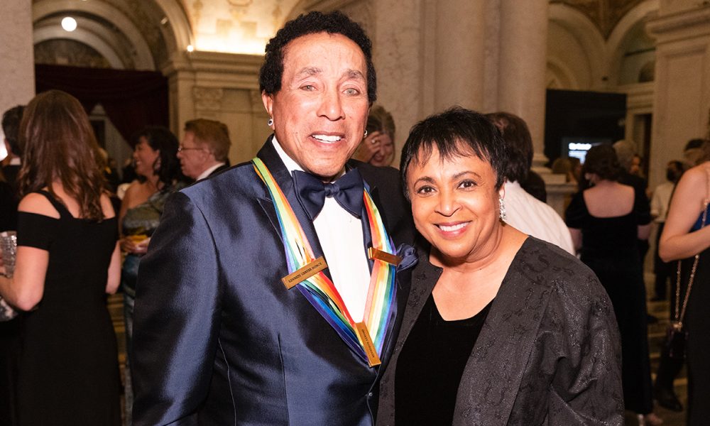 Once identified by Bob Dylan as America’s “greatest living poet,” legendary recording artist, lyricist and composer Smokey Robinson, is a Rock’ n’ Roll Hall of Fame and Songwriters’ Hall of Fame inductee. Photo: Librarian of Congress Carla Hayden greets Smokey Robinson at the Kennedy Center Honors Medallion Ceremony at the Library of Congress, December 4, 2021. Photo by Shawn Miller/Library of Congress.