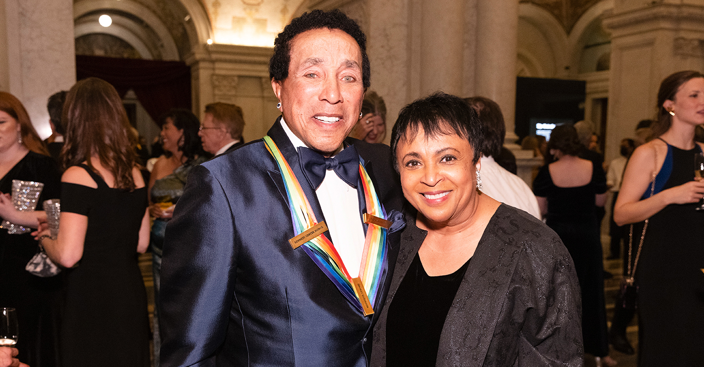 Once identified by Bob Dylan as America’s “greatest living poet,” legendary recording artist, lyricist and composer Smokey Robinson, is a Rock’ n’ Roll Hall of Fame and Songwriters’ Hall of Fame inductee. Photo: Librarian of Congress Carla Hayden greets Smokey Robinson at the Kennedy Center Honors Medallion Ceremony at the Library of Congress, December 4, 2021. Photo by Shawn Miller/Library of Congress.