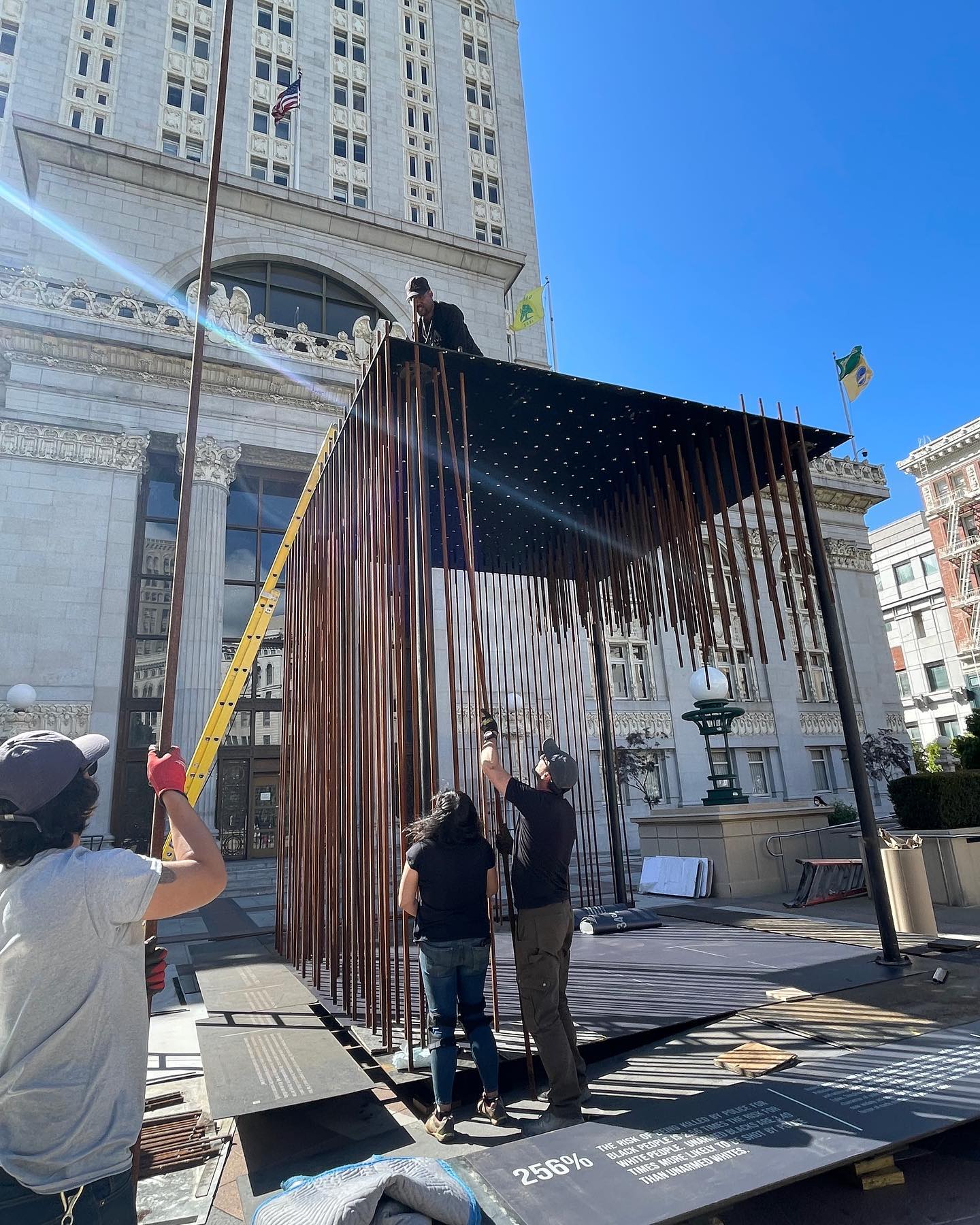 Support Oakland Artists Executive Director Randolph Belle atop the installation called ‘Society’s Cage’ as it was being assembled. Photo courtesy of Facebook.