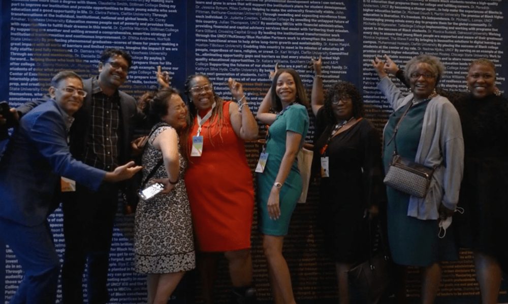 Conference guests point out their school’s name at UNITE 2022 (photo courtesy of United Negro College Fund)