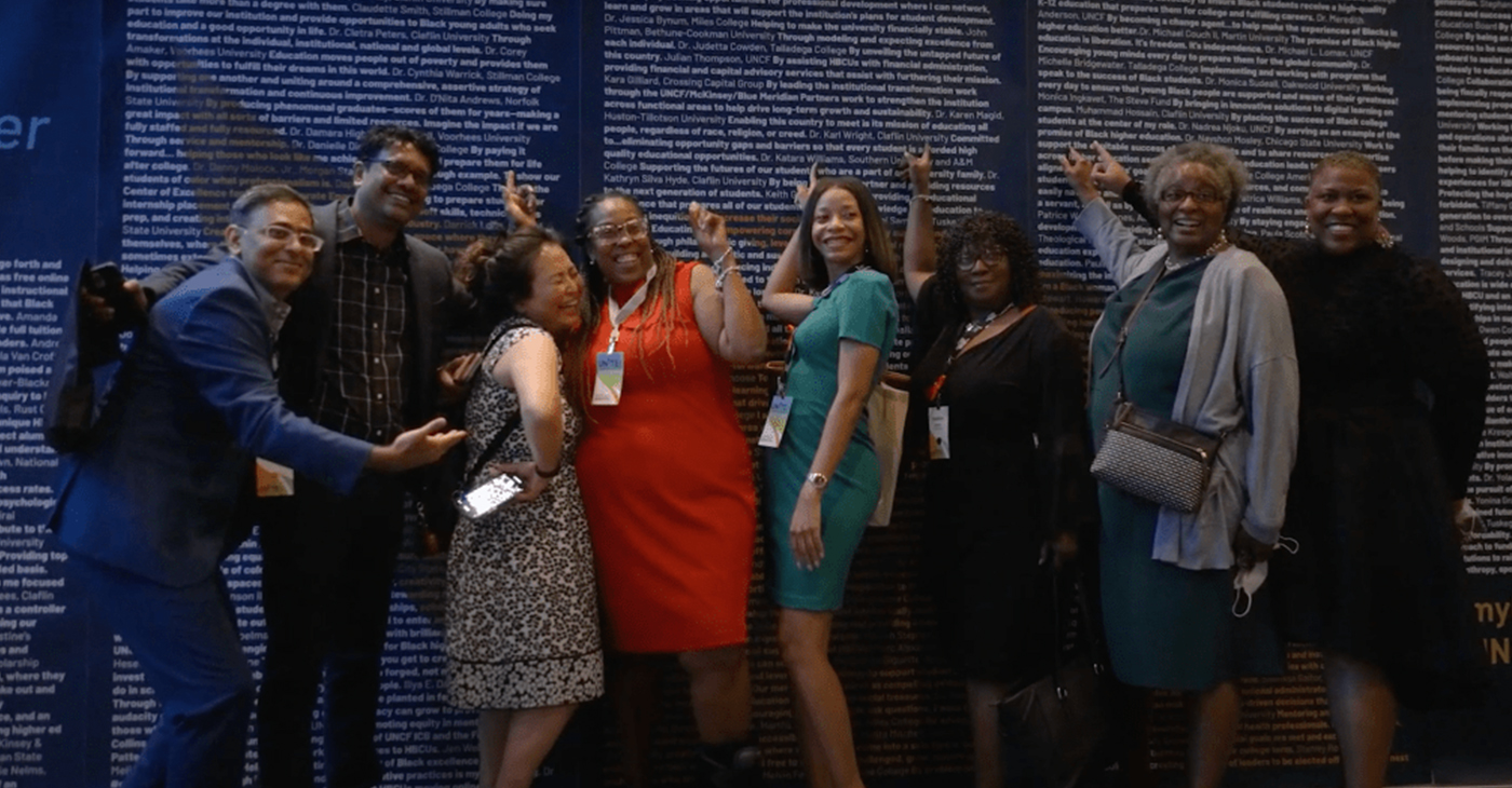Conference guests point out their school’s name at UNITE 2022 (photo courtesy of United Negro College Fund)