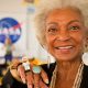 Actress Nichelle Nichols, known for her most famous role as communications officer Lieutenant Uhura aboard the USS Enterprise in the popular Star Trek television series, displays her Lego astronaut ring while visiting the "Build the Future" activity where students created their vision of the future in space with LEGO bricks and elements inside a tent that was set up on the launch viewing area at NASA's Kennedy Space Center in Cape Canaveral, Fla. on Monday, Nov. 1, 2010. NASA and The LEGO Group signed a Space Act Agreement to spark children's interest in science, technology, engineering and math (STEM). Photo Credit: (NASA/Bill Ingalls