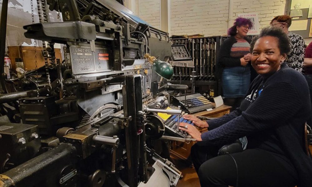 Denise Dorsey sits in front of a machine that creates linotype molds for the purposes of printing at the Baltimore Museum of Industry. Since 1976 she has been mastering the technology needed to produce the pages of the AFRO American Newspaper. (Photo by Alexis Taylor)