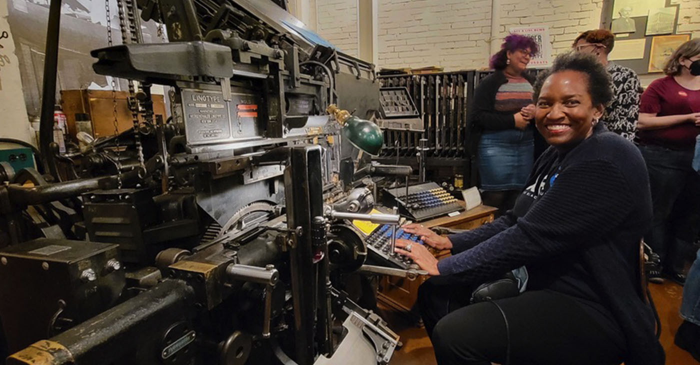 Denise Dorsey sits in front of a machine that creates linotype molds for the purposes of printing at the Baltimore Museum of Industry. Since 1976 she has been mastering the technology needed to produce the pages of the AFRO American Newspaper. (Photo by Alexis Taylor)