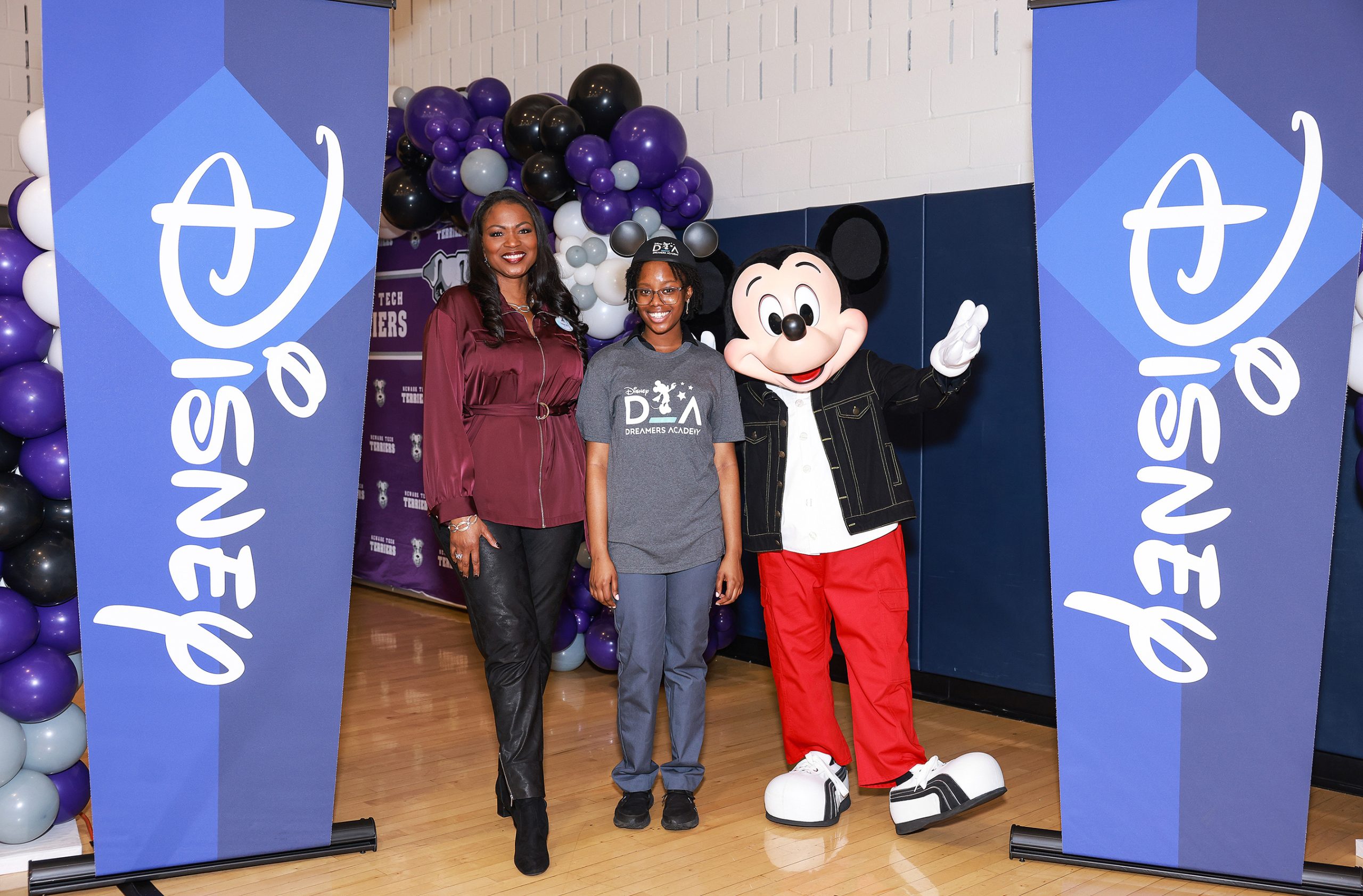 Mickey Mouse and Disney Dreamers Academy executive champion Tracey Powell pose with Newark Tech (N.J.) high school student Mosope Aina moments after she was surprised on national TV on January 13, 2023 with the news that she is one of 100 students selected for this year’s Disney Dreamers Academy at Walt Disney World Resort in Florida in March. Also, the names of all 100 Dreamers were displayed on a Times Square billboard. Disney Dreamers Academy is a mentoring program hosted annually at Walt Disney World Resort to foster the dreams of Black students and teens from underrepresented communities. (ABC/Michael Le Brecht II)
