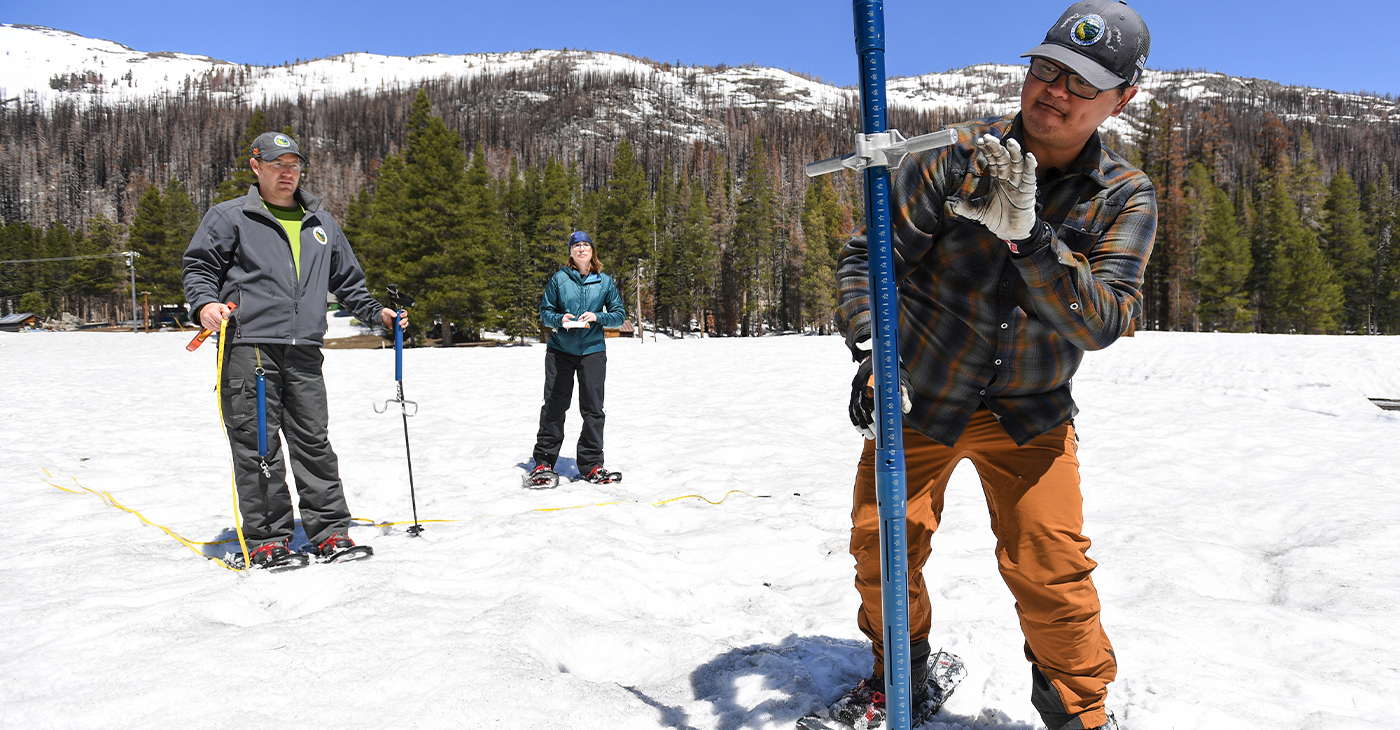 Sean de Guzman, Manager of the California Department of Water Resources Snow Surveys and Water Supply Forecasting Unit, and Anthony Burdock, Department of Water Resources engineer in the Snow Surveys and Water Supply Forecasting Unit, examine the aluminum survey pole during the final snow survey of the 2023 season on May 1, 2023 at Phillips Station in the Sierra Nevada Mountains in El Dorado County, Calif. (Ken James/California Department of Water Resources via Bay City News)