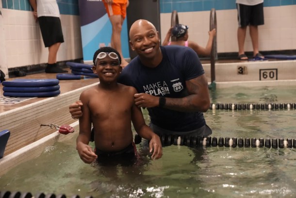 Cullen Jones (right) and student at a recent ‘Make a Splash’ swimming lesson in Houston, TX. Photograph courtesy of Mike Lewis/USA Swimming. 