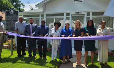 Representatives of Friends of Juanita J. Craft House, Junior League of Dallas and City of Dallas during the ribbon-cutting of the Juanita J. Craft House. Photo by Raven Jordan of the Dallas Weekly, Raven Jordan, The Dallas Weekly, Juanita J. Craft House, South Dallas historical landmark, Civil Rights Museum, Juanita J. Craft, activist, former Democratic Precinct Chair, NAACP leader, former Dallas City Council member, advance desegregation, racial equality, Dallas, gathering spot, Black youth, South Dallas community, The Junior League of Dallas, City of Dallas Arts and Culture, Friends of Juanita J. Craft Civil Rights House & Museum, restore the house, restoration, rehabilitation, Ceremony, audio clip, Candace Thompson, Black National Anthem, "Lift Every Voice and Sing", American, darker hue, segregation, project to restore and reopen the house, "labor of love", significant day, life of our history, celebrate, significant leader, history of our city, entire world, Dallas City Councilman Adam Bazaldua, Craft's political history, desegregate the State Fair of Texas, boycotts, Black residents, "Negro Appeasement Day", two terms on council, Craft Kids, civil rights, Dallas Youth Council, Patricia Perez, Lyft, walked the path I used to walk, empowering, ribbon cutting, reception in the garden, snacks, drinks, Juanita J. Craft pins, tour the house, painted walls, facts and moments from Craft’s long career, display cases, memorabilia