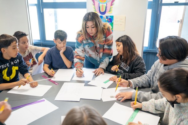 Fifth-grade students patiently watch Andrea Rodriguez demonstrate their next arts assignment. Russell Stiger Jr. OBSERVER