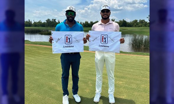 Christian Heavens (left) and Quinn Riley display TPC Louisiana pin flags after winning the APGA Two-Man Classic in Avondale (suburban New Orleans) Tuesday afternoon.