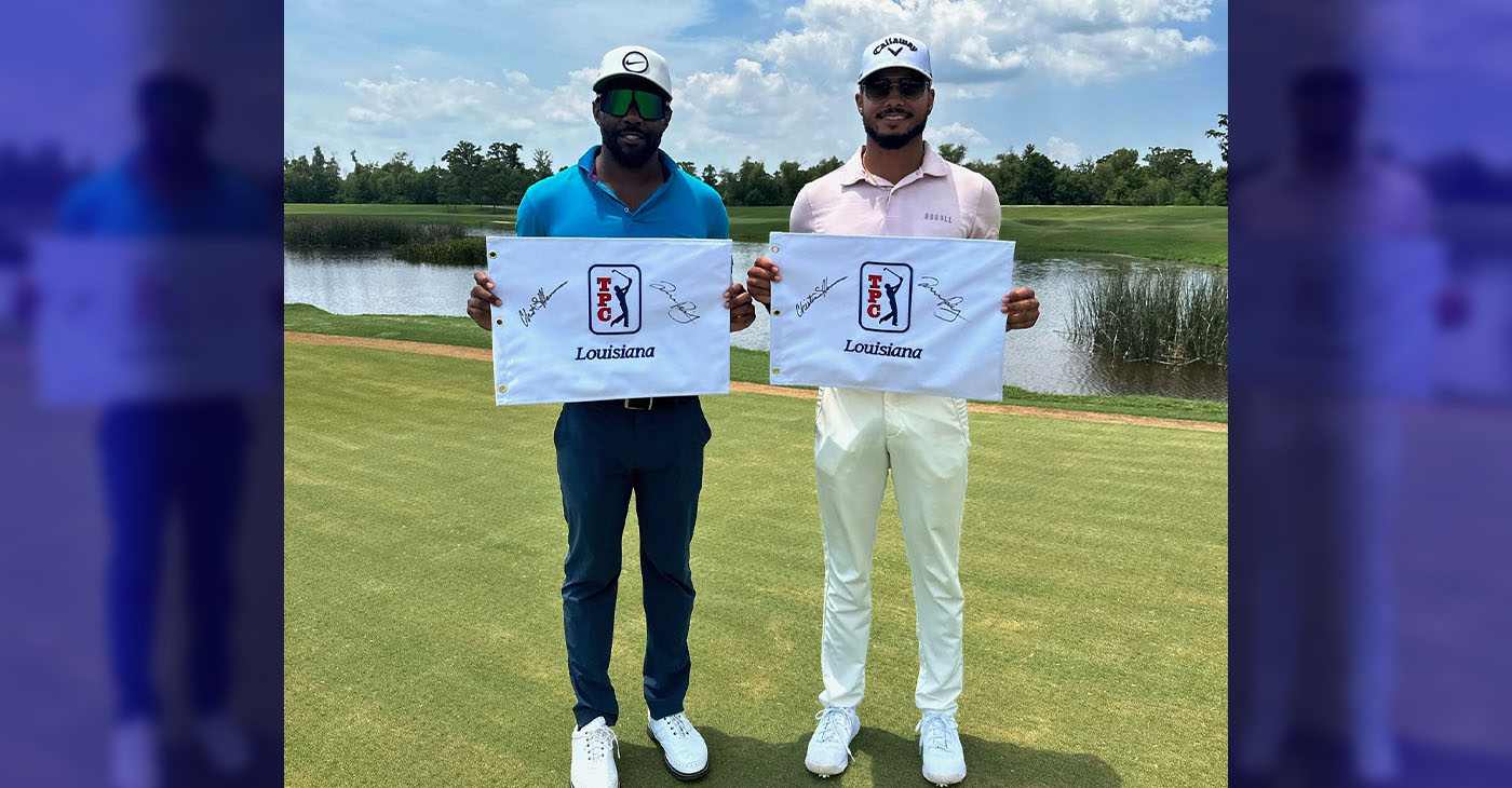 Christian Heavens (left) and Quinn Riley display TPC Louisiana pin flags after winning the APGA Two-Man Classic in Avondale (suburban New Orleans) Tuesday afternoon.