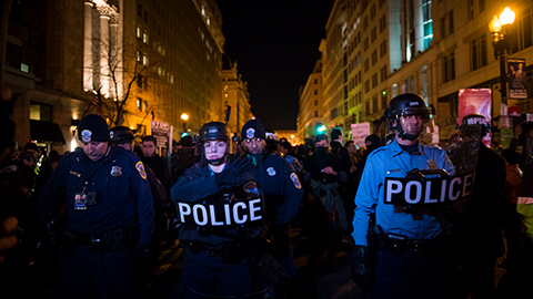 Washington DC, USA - January 19, 2017: Washington Metropolitan Police stand on 14th Street holding shields during protest on the eve of President-elect Trump's inauguration. (Photo: iStockphoto / NNPA)